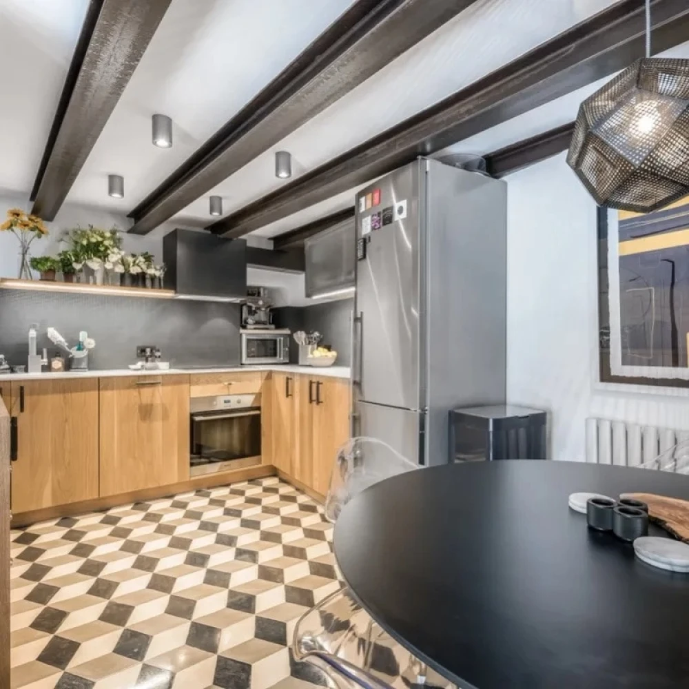 Kitchen, oaks cabinets, silver fridge and black table