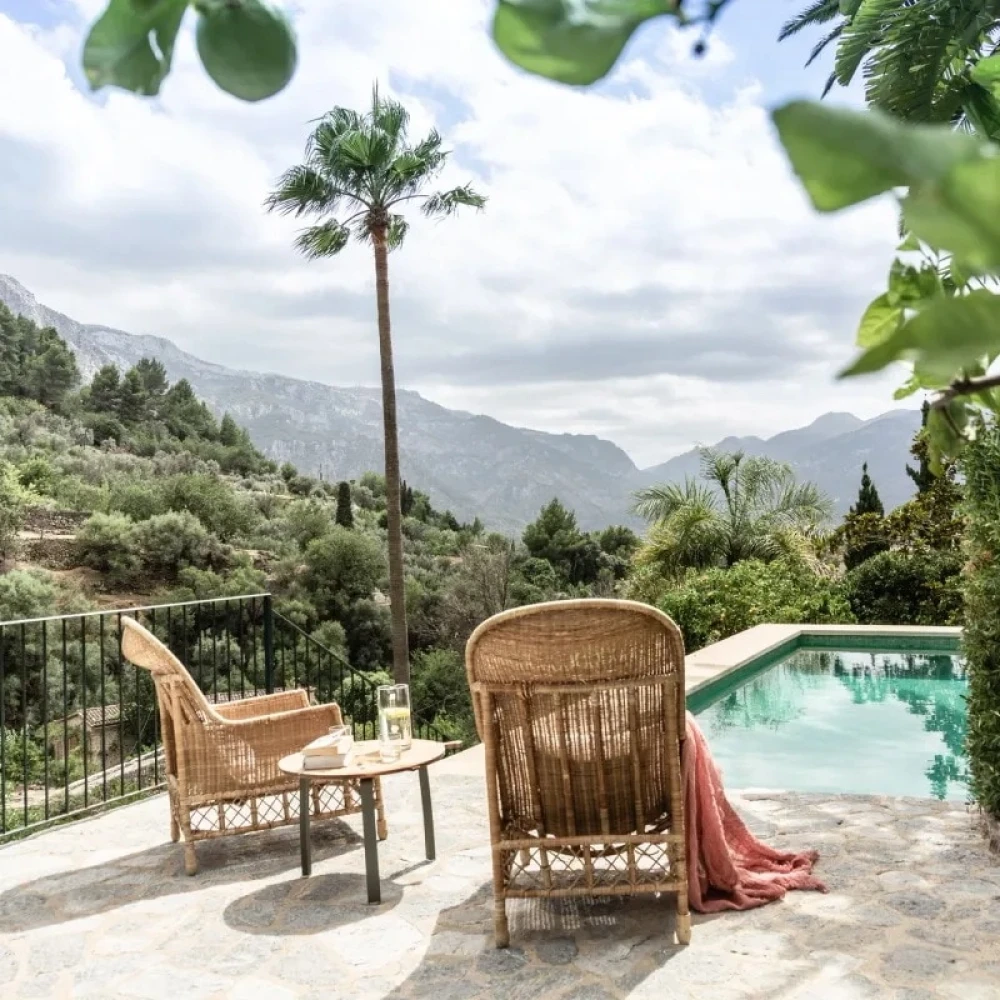 Outdoor pool with two chairs and a table