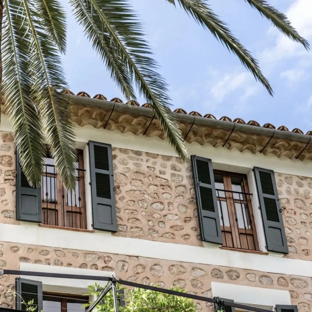 Grey window shutters on side of a villa